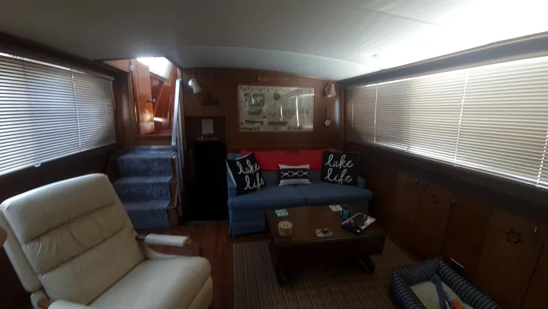 Slide: The Image of Interior of 1965 Chris-Craft 56 Roamer yacht with cozy seating and nautical decor. - 17