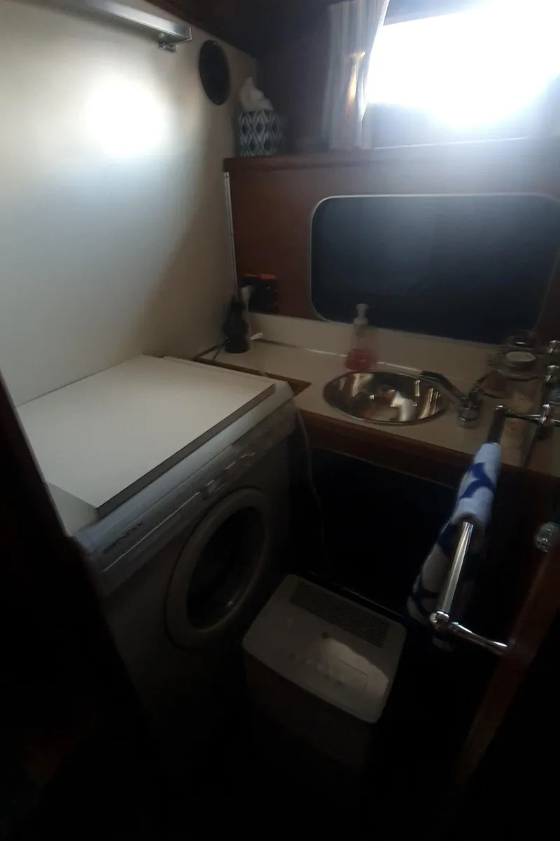 Slide: The Image of 1965 Chris-Craft 56 Roamer yacht interior with washing machine and sink. - 23