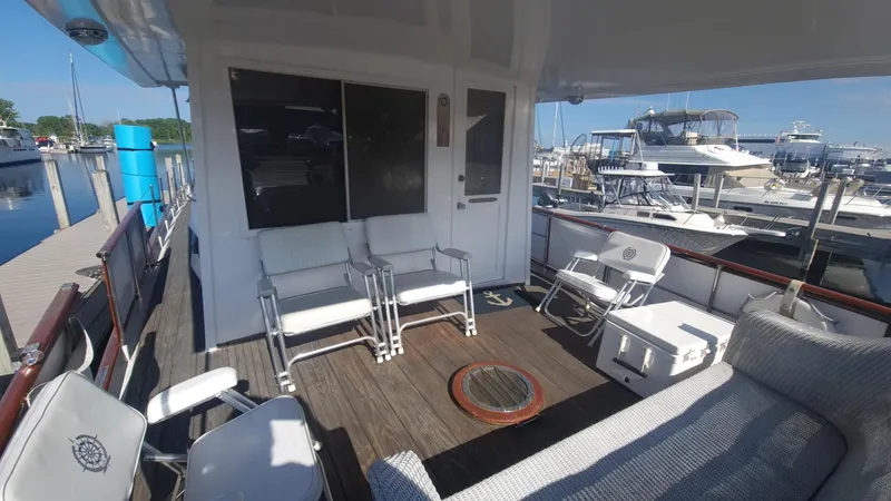 Slide: The Image of 1965 Chris-Craft 56 Roamer yacht deck with seating at marina. - 4
