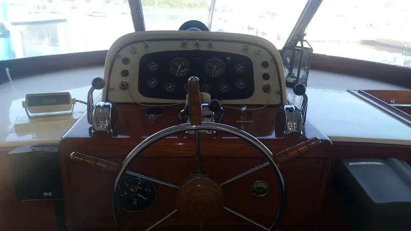 Slide: The Image of 1965 Chris-Craft 56 Roamer boat helm with classic wooden steering wheel and instrument panel. - 8