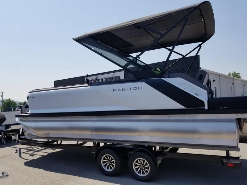 Slide: The Image of 2025 Manitou Cruise pontoon boat on trailer with canopy. - 19