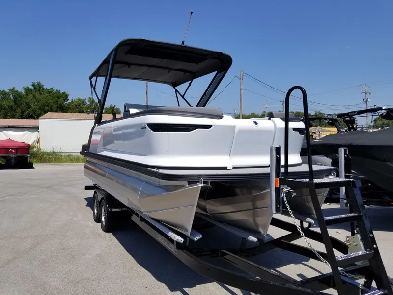Slide: The Image of 2025 Manitou Cruise pontoon boat on trailer, ready for transport. - 2