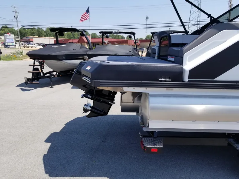 Slide: The Image of 2025 Manitou Cruise pontoon boats displayed in a dealership lot. - 24