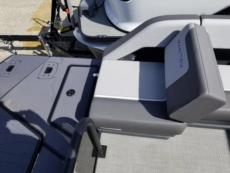 Slide: The Image of 2025 Manitou Cruise boat interior with gray seating and deck. - 28