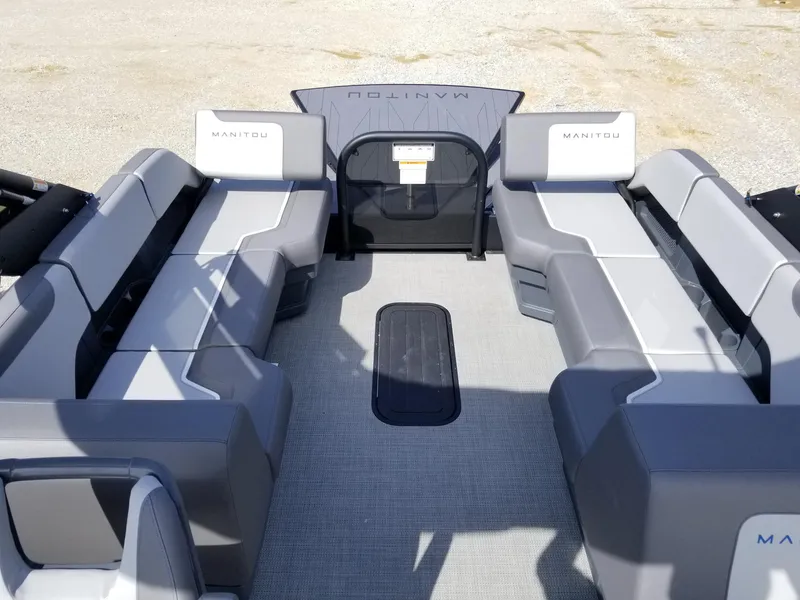 Slide: The Image of 2025 Manitou Cruise pontoon boat interior with spacious seating and modern design. - 30
