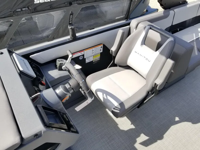 Slide: The Image of 2025 Manitou Cruise boat interior with steering wheel and captain's seat. - 31