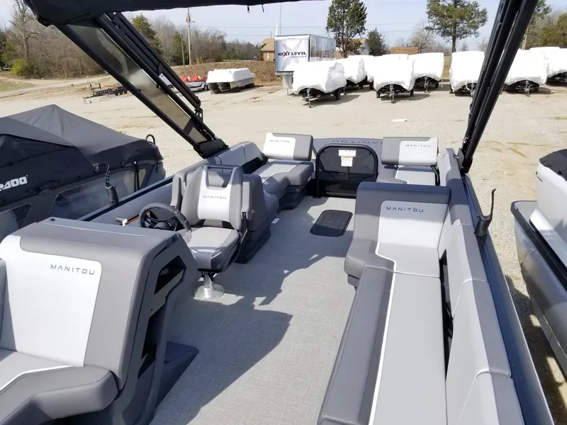 Slide: The Image of 2025 Manitou Cruise pontoon boat with spacious seating and modern design. - 34