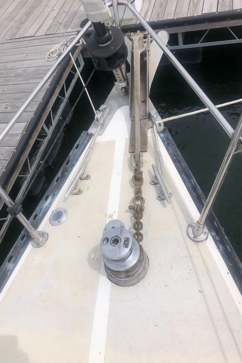 Slide: The Image of 1980 Tartan 33 sailboat bow with anchor chain and winch at dock. - 12