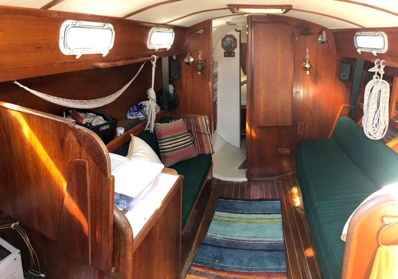 Slide: The Image of Interior of 1980 Tartan 33 sailboat with wooden furnishings and cozy seating. - 15