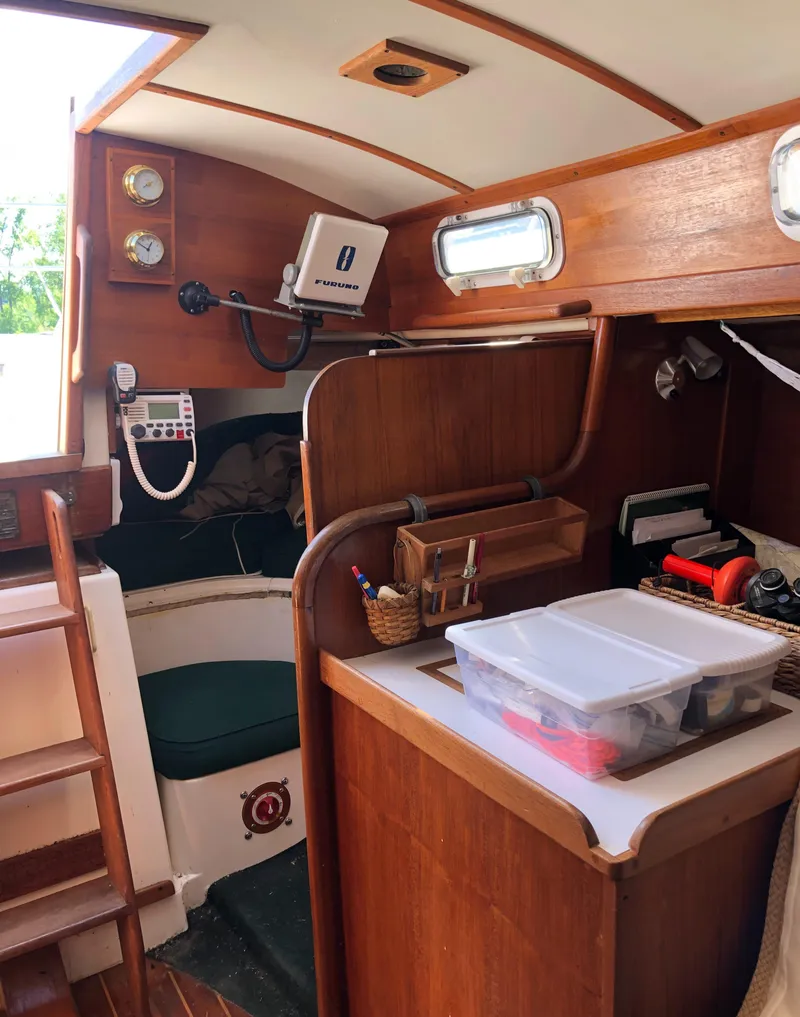 Slide: The Image of Interior of a 1980 Tartan 33 sailboat with wooden cabinetry and navigation equipment. - 17