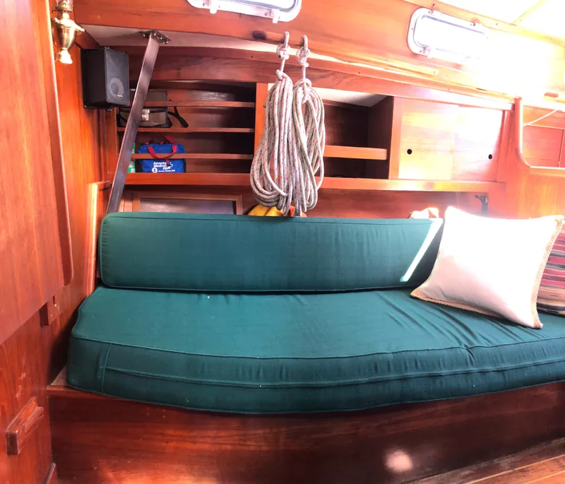 Slide: The Image of Interior of 1980 Tartan 33 sailboat with green cushion and wooden shelves. - 20
