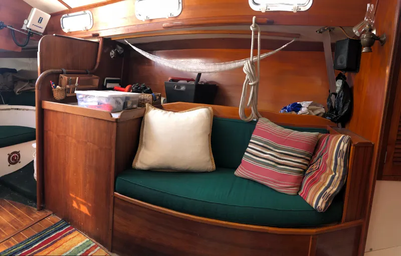 Slide: The Image of Cozy interior of a 1980 Tartan 33 sailboat with colorful cushions and wooden accents. - 22