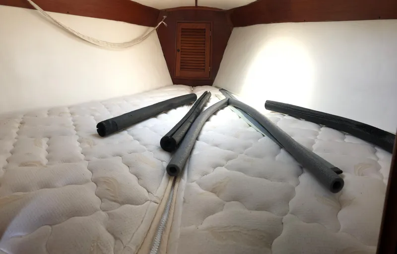 Slide: The Image of Cozy cabin interior of 1980 Tartan 33 sailboat with mattress and foam tubes. - 25