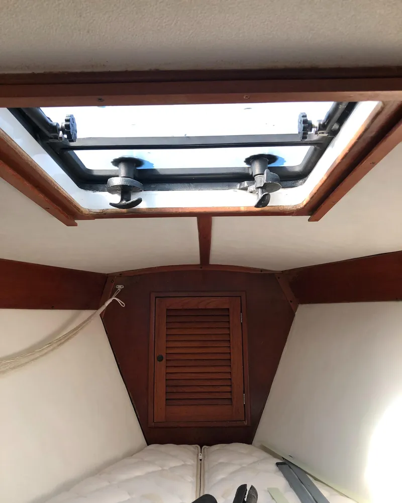 Slide: The Image of 1980 Tartan 33 sailboat interior with wooden hatch and cozy cabin space. - 26