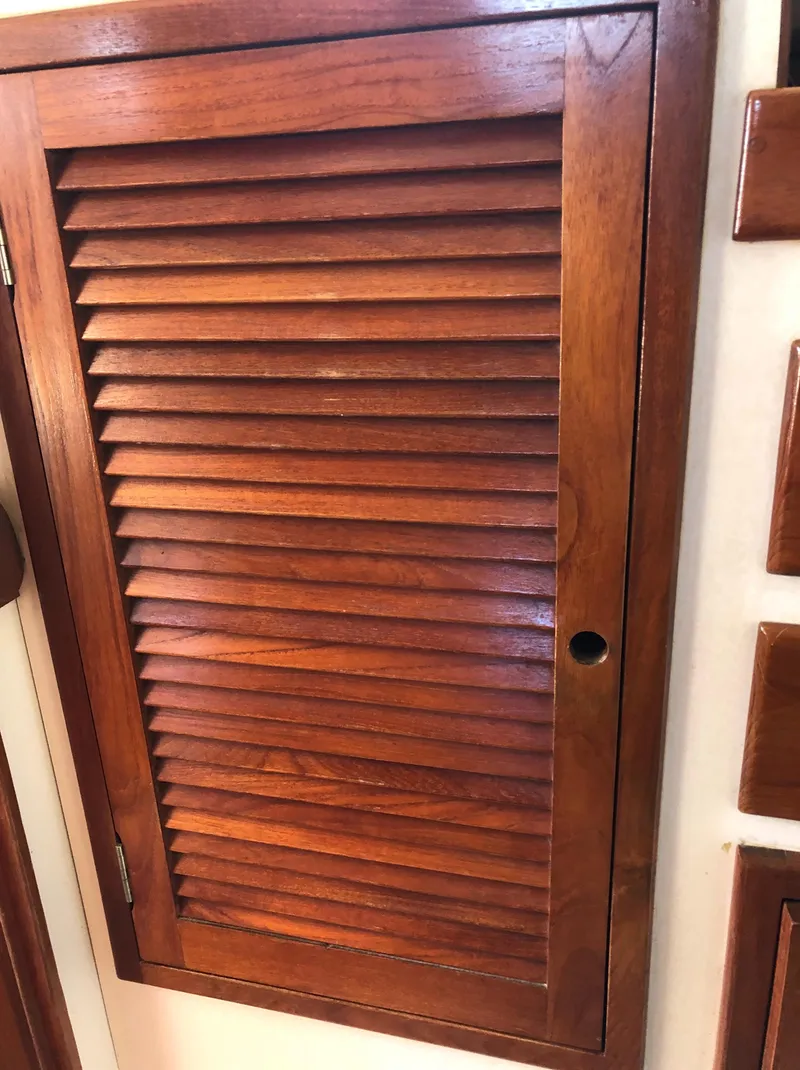 Slide: The Image of Wooden louvered cabinet door on a 1980 Tartan 33 sailboat interior. - 30
