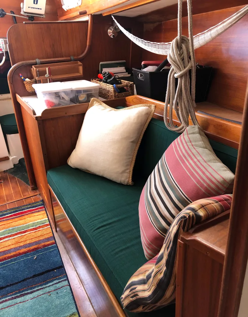 Slide: The Image of Cozy interior of 1980 Tartan 33 sailboat with colorful cushions and wooden accents. - 31