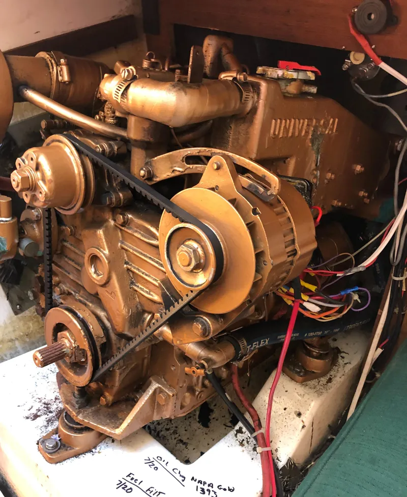 Slide: The Image of Engine of a 1980 Tartan 33 sailboat with visible belts and wiring. - 37