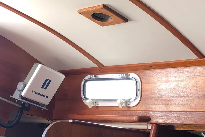 Slide: The Image of Interior of a 1980 Tartan 33 sailboat with wooden paneling and a Furuno device. - 38