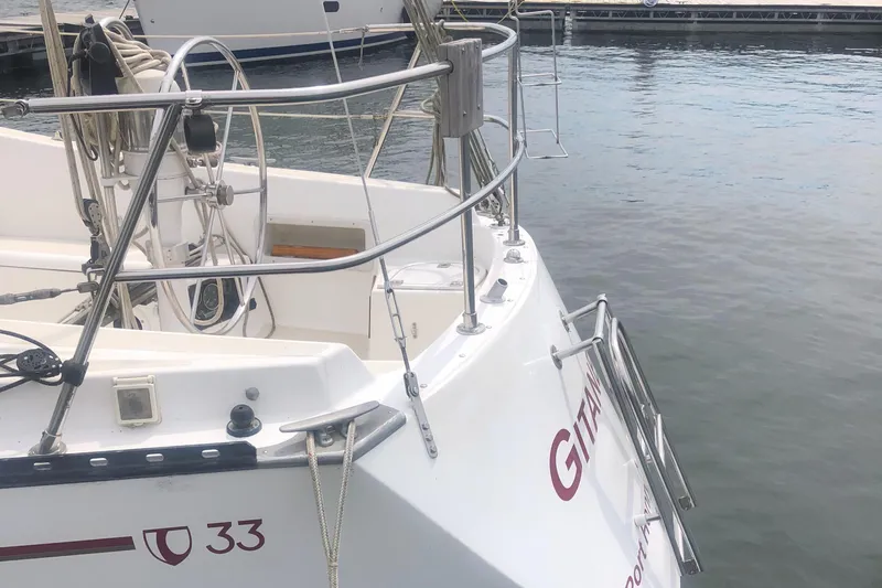 Slide: The Image of 1980 Tartan 33 sailboat docked at marina, featuring sleek design and sturdy railings. - 5