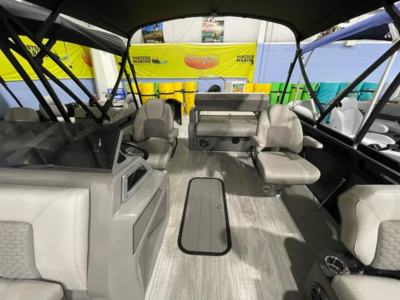 Slide: The Image of 2023 Apex Marine M22 boat interior with seating and canopy. - 6