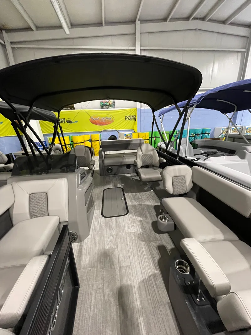 Slide: The Image of 2023 Apex Marine M22 pontoon boat interior with spacious seating and canopy. - 7