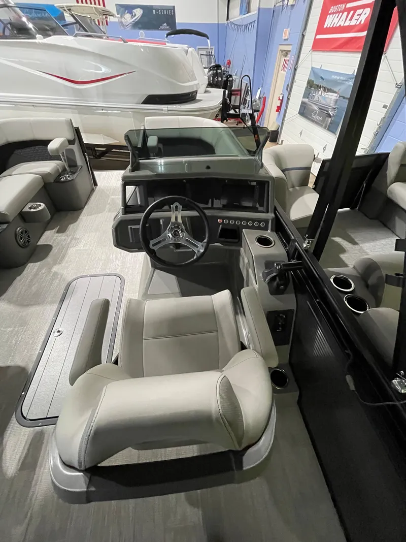 Slide: The Image of 2023 Apex Marine M 22 boat interior with modern helm and seating. - 4