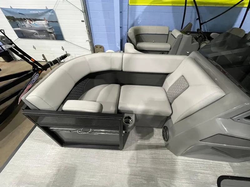 Slide: The Image of 2023 Apex Marine M 22 boat interior with gray seating and cup holders. - 7