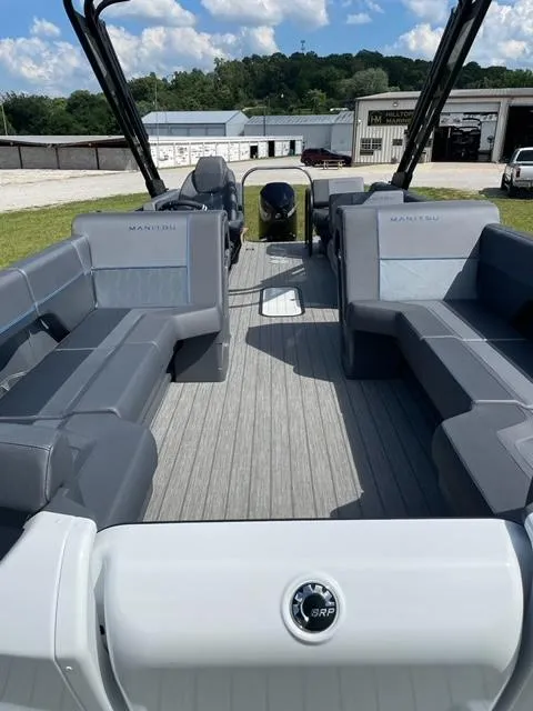Slide: The Image of 2023 Manitou 24 Explore SB pontoon boat interior with gray seating and flooring. - 0