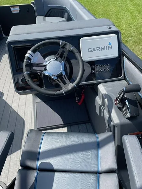 Slide: The Image of 2023 Manitou 24 Explore SB boat dashboard with Garmin navigation system. - 4