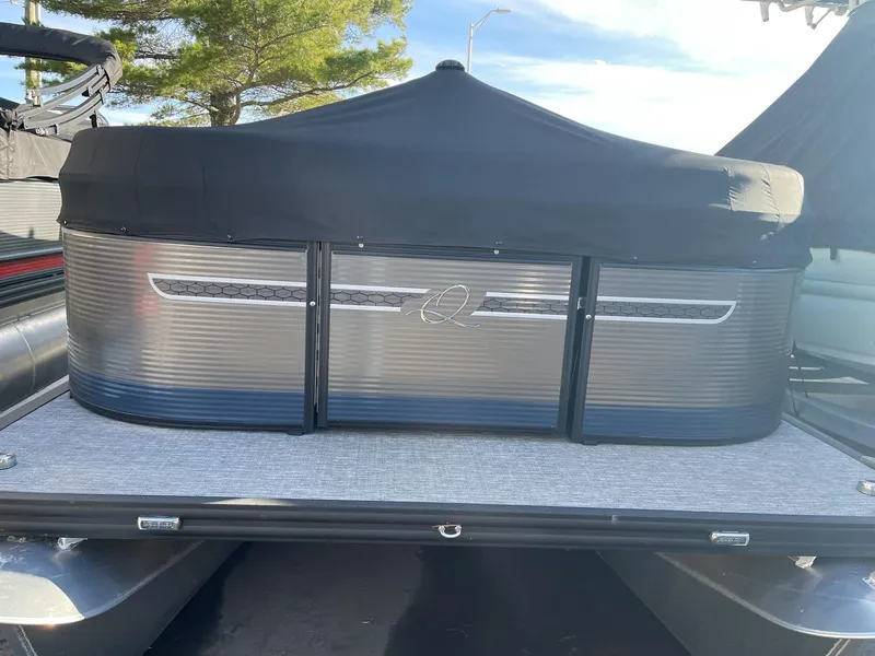 Slide: The Image of 2023 Apex Marine E 818 pontoon boat with a sleek, covered design. - 11