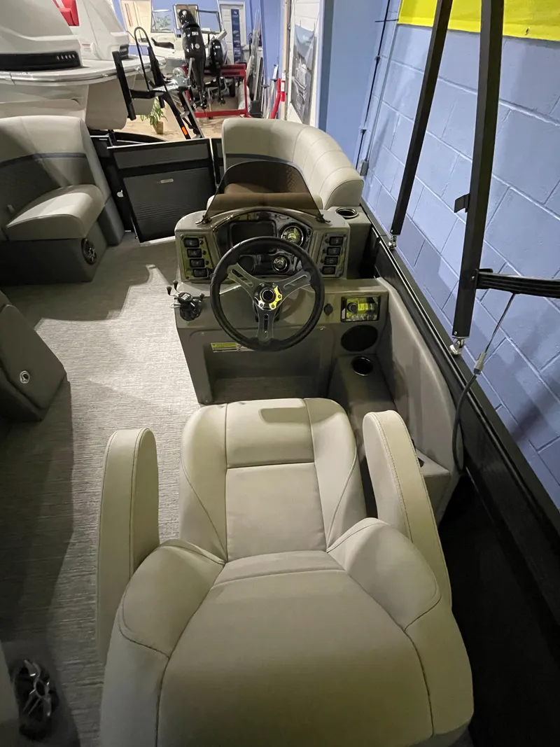 Slide: The Image of 2023 Apex Marine E 818 boat interior with steering console and seating. - 3