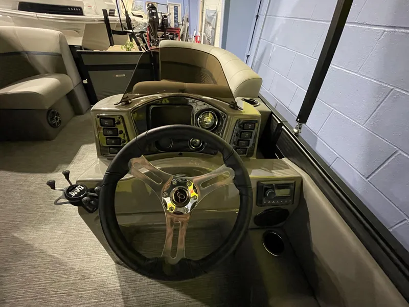 Slide: The Image of 2023 Apex Marine E 818 boat cockpit with steering wheel and control panel. - 4