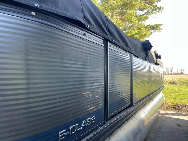 Slide: The Image of 2023 Apex Marine E 818 pontoon boat with E-Glass panels, docked outdoors. - 9