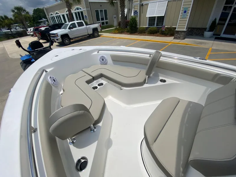 Slide: The Image of 2024 Key West 203 FS boat with beige seating in a parking lot. - 19