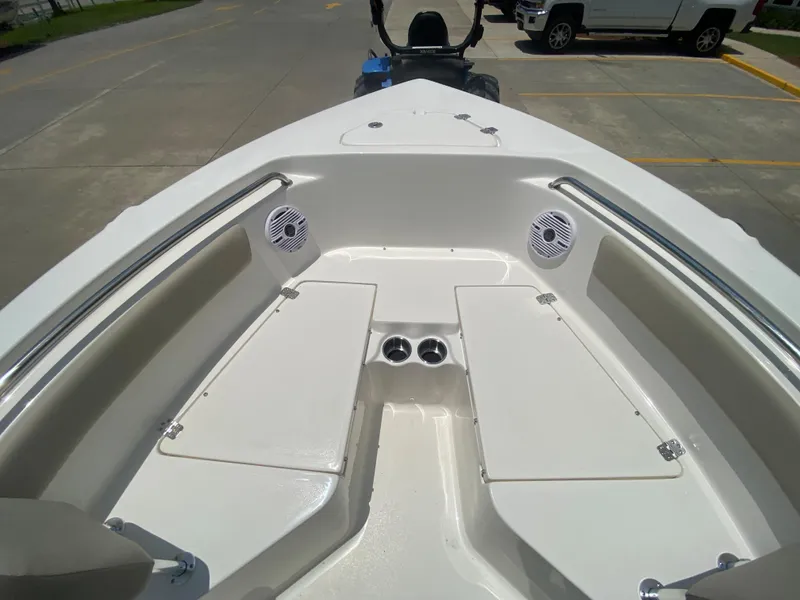 Slide: The Image of 2024 Key West 203 FS boat bow seating area with storage compartments and speakers. - 21