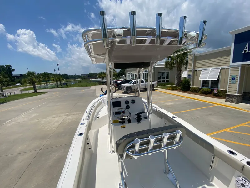 Slide: The Image of 2024 Key West 203 FS boat with T-top and console, parked in a lot. - 6