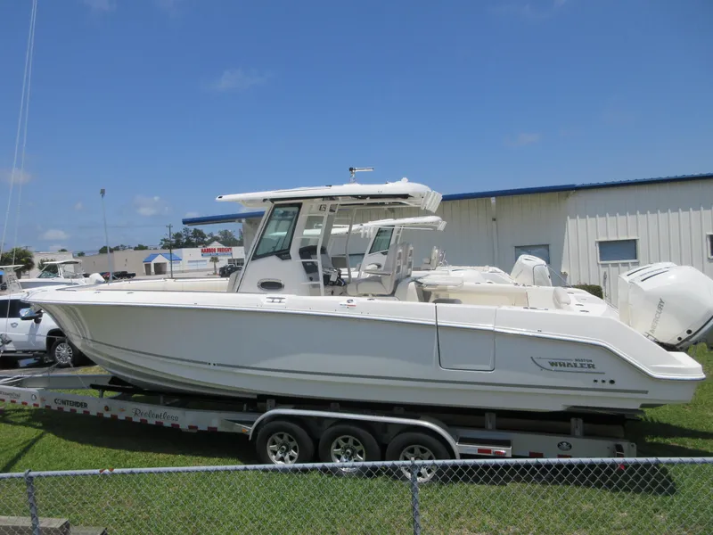 Slide: The Image of 2023 Boston Whaler 33 OUTRAGE boat on a trailer, side view. - 1