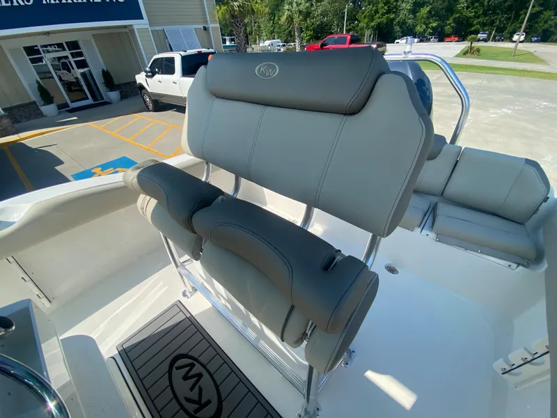 Slide: The Image of 2024 Key West 219 FS boat with cushioned seating and backrest. - 12