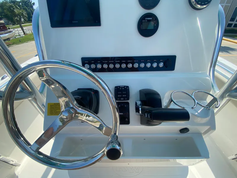 Slide: The Image of 2024 Key West 219 FS boat console with steering wheel and controls. - 15
