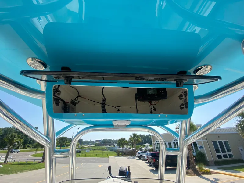 Slide: The Image of 2024 Key West 219 FS boat console with blue T-top and electronics. - 16
