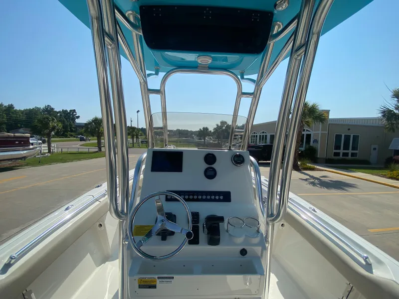 Slide: The Image of 2024 Key West 219 FS boat console with steering wheel and controls. - 17