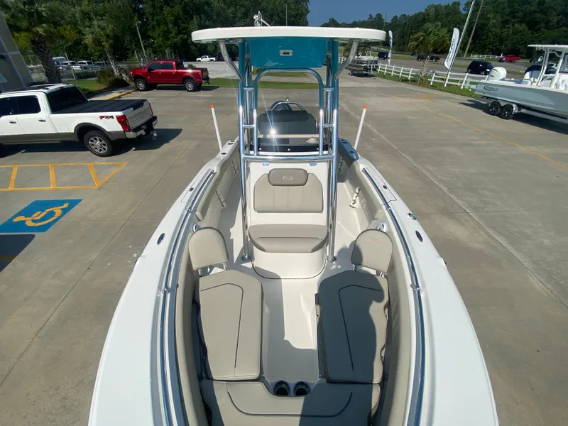 Slide: The Image of 2024 Key West 219 FS boat with spacious seating and T-top in a parking lot. - 19