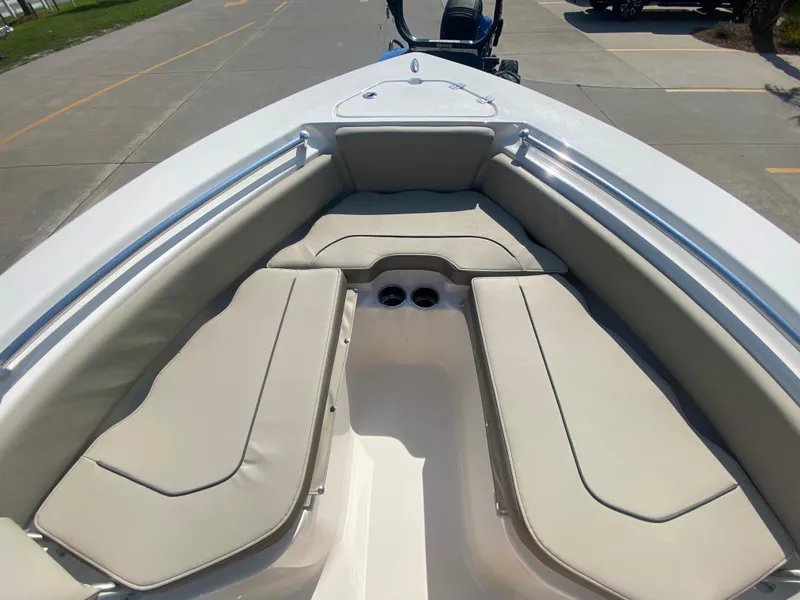 Slide: The Image of 2024 Key West 219 FS boat with cushioned seating and cup holders. - 20