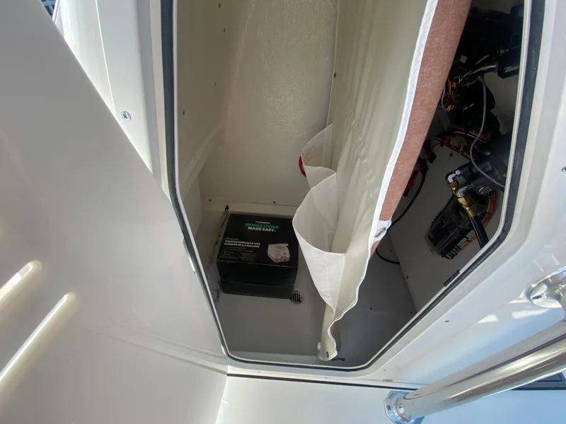 Slide: The Image of 2024 Key West 219 FS boat storage compartment with equipment. - 26