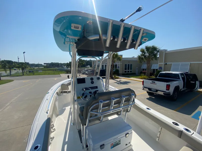 Slide: The Image of 2024 Key West 219 FS boat with T-top and center console in a marina parking lot. - 6