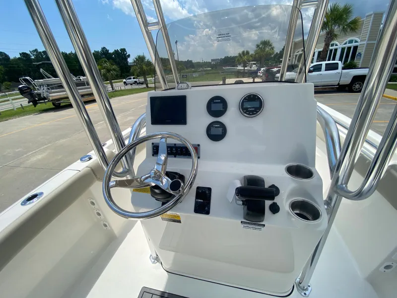 Slide: The Image of 2024 Key West 203 FS boat console with steering wheel, gauges, and controls. - 15