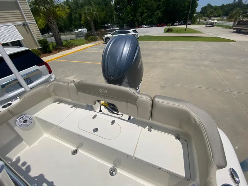 Slide: The Image of 2024 Key West 203 FS boat stern with outboard motor in parking lot. - 8