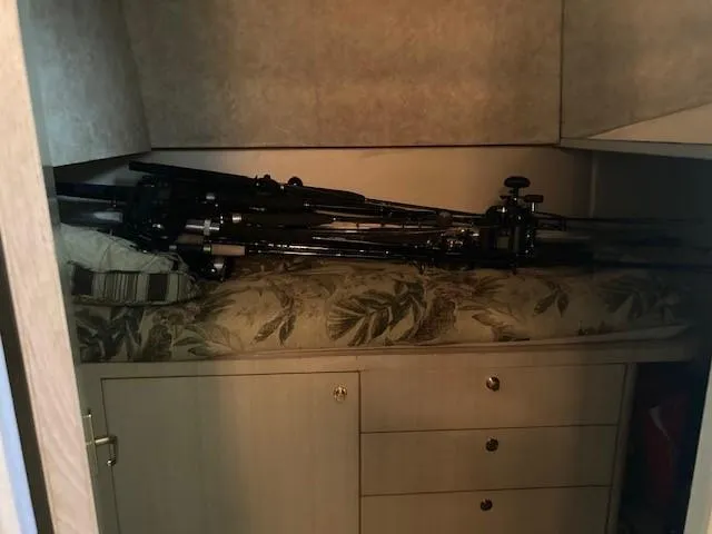 Slide: The Image of 1998 Ocean Yachts 45 Super Sport cabin with fishing rods on bed - 10