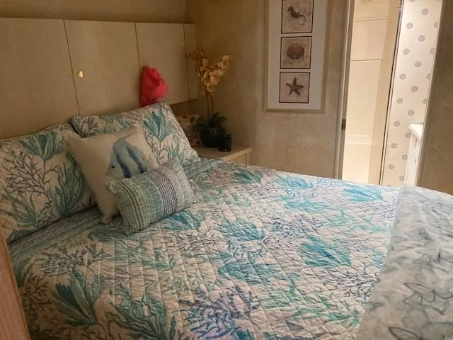 Slide: The Image of Cozy bedroom in 1998 Ocean Yachts 45 Super Sport with ocean-themed decor. - 13