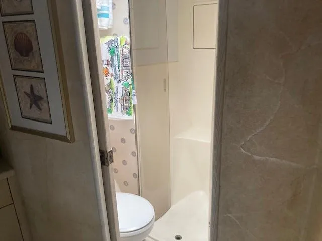 Slide: The Image of 1998 Ocean Yachts 45 Super Sport bathroom with shower and framed marine art. - 14